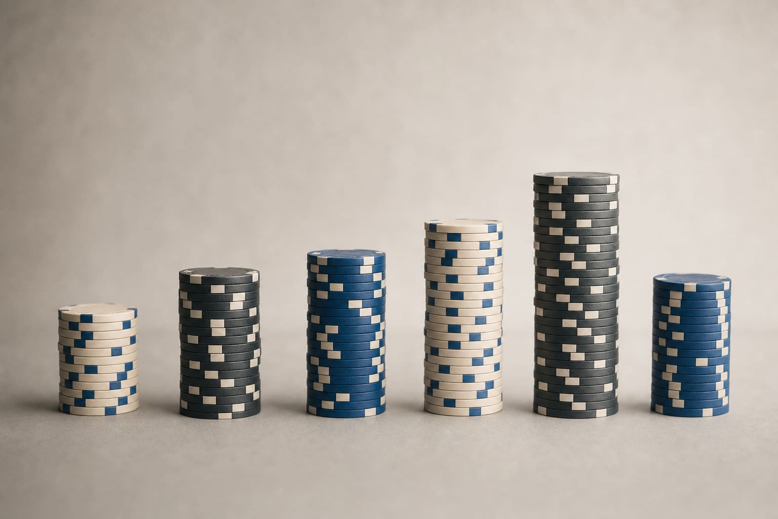 Columns of casino chips of different heights lined up in a row like the bars of a chart